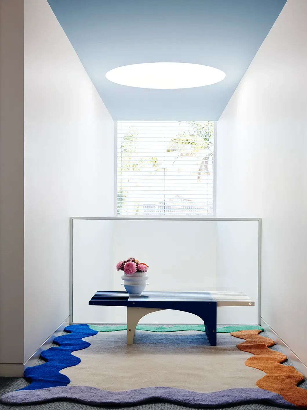 Corridor with pale blue ceiling and white walls