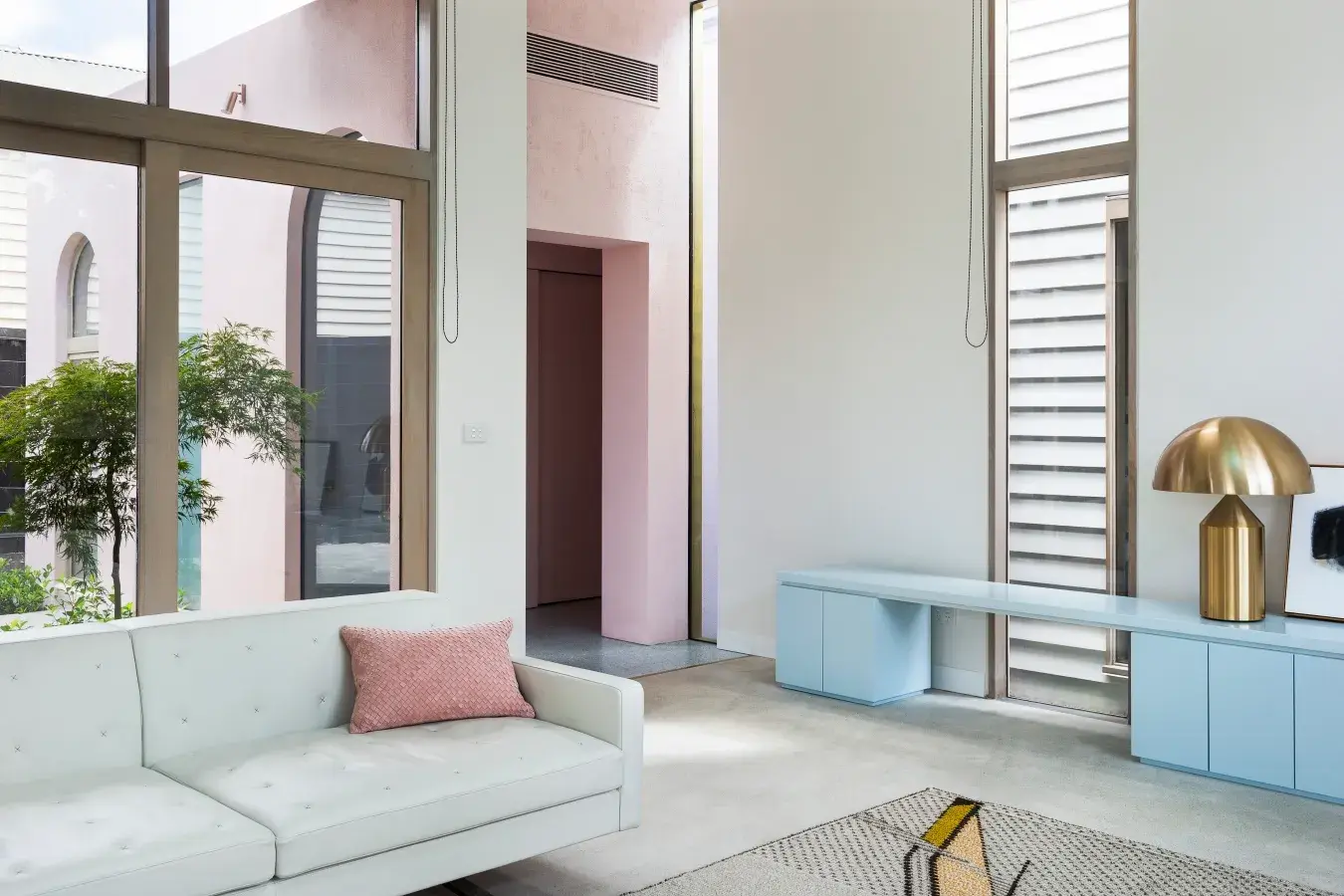 White and pink living room with blue console