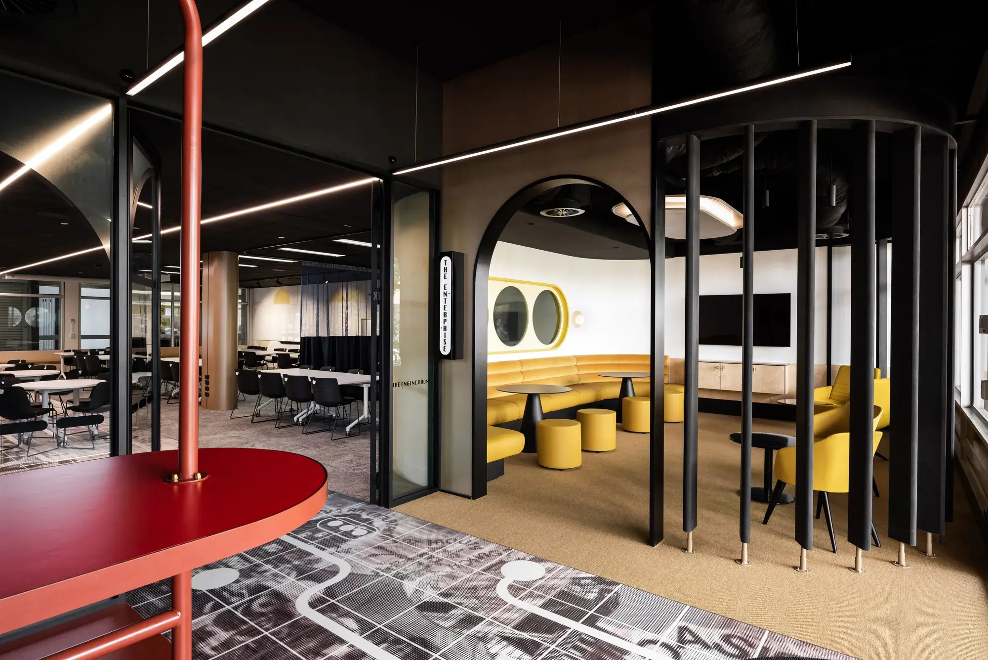 Open plan room with nooks for study, tables, chairs.