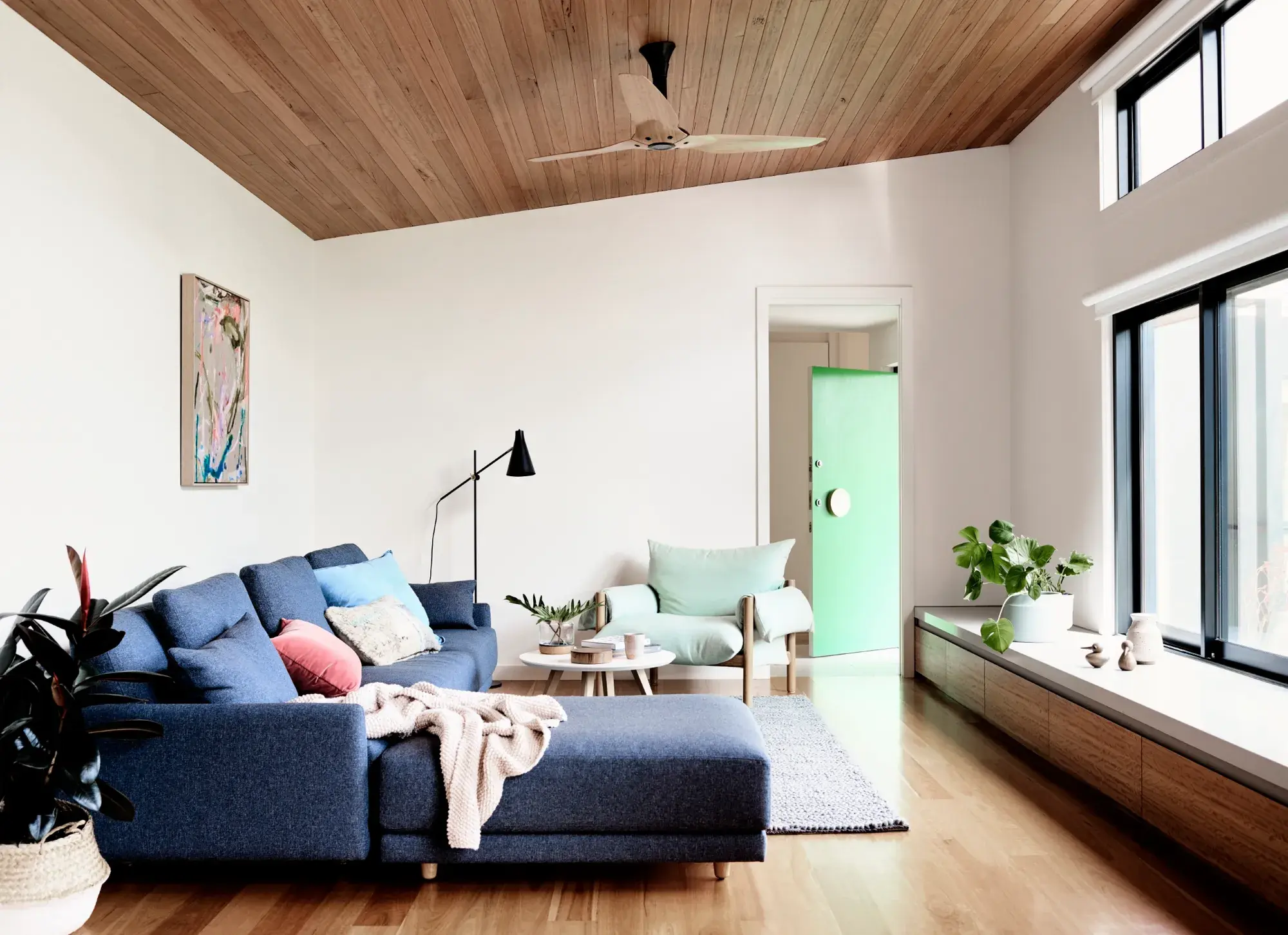 interior white lounge room with blue couch.