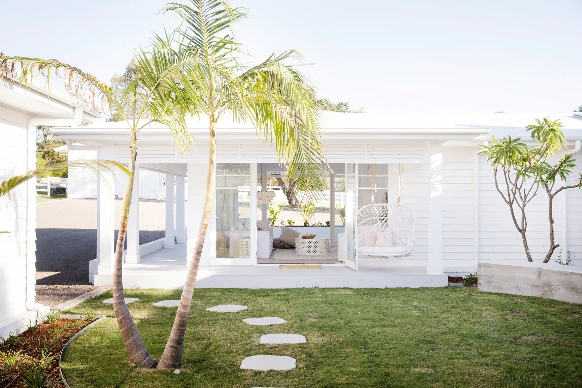 White house exterior with palm tree in foreground