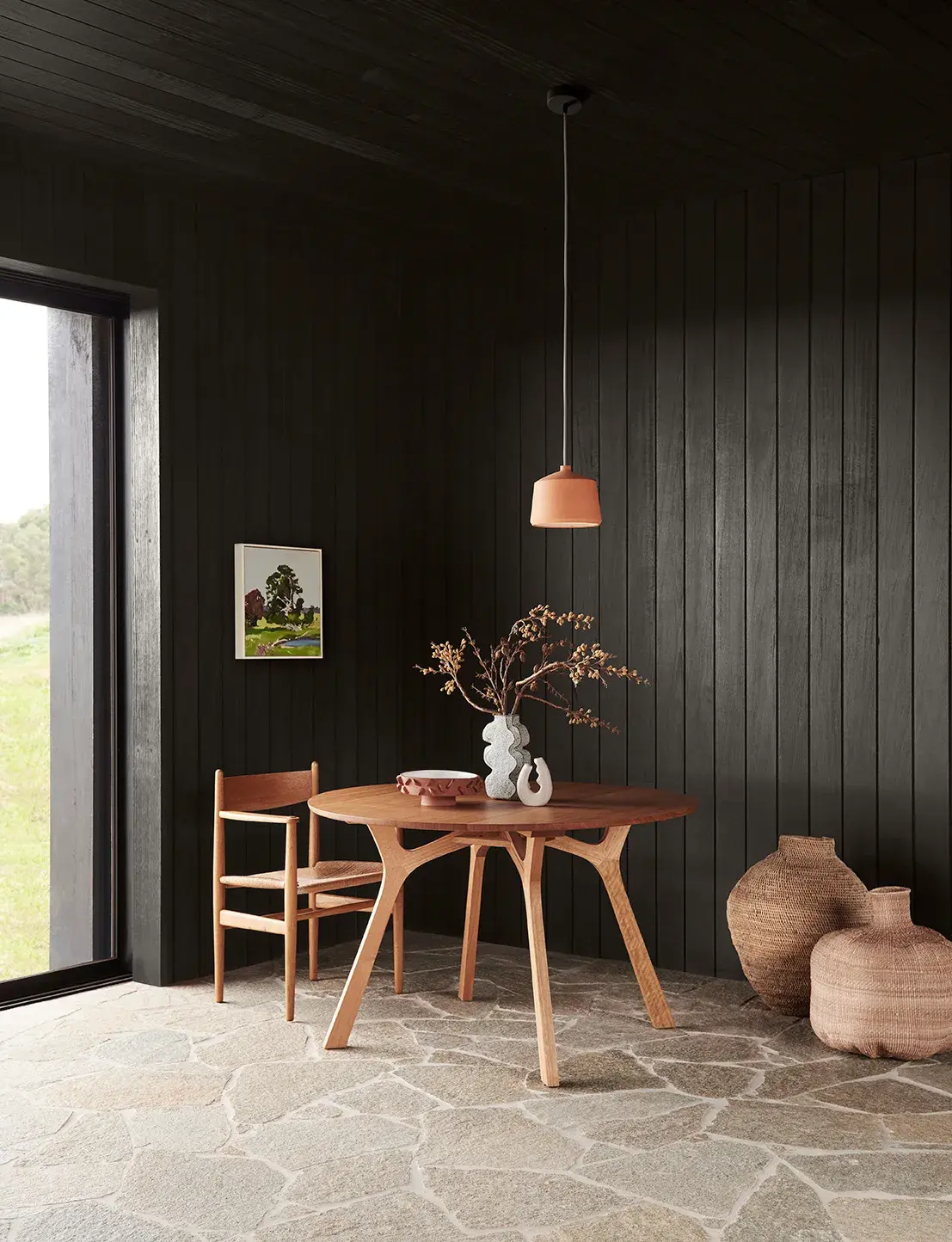 Dining space with paved stone floors and black panelled walls