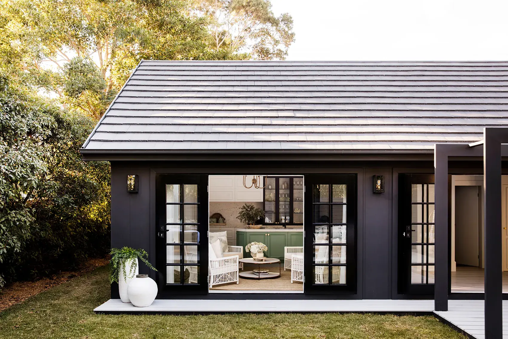 Black exterior house renovation with French doors