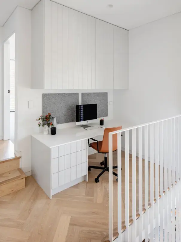 White airy study nook with orange chair