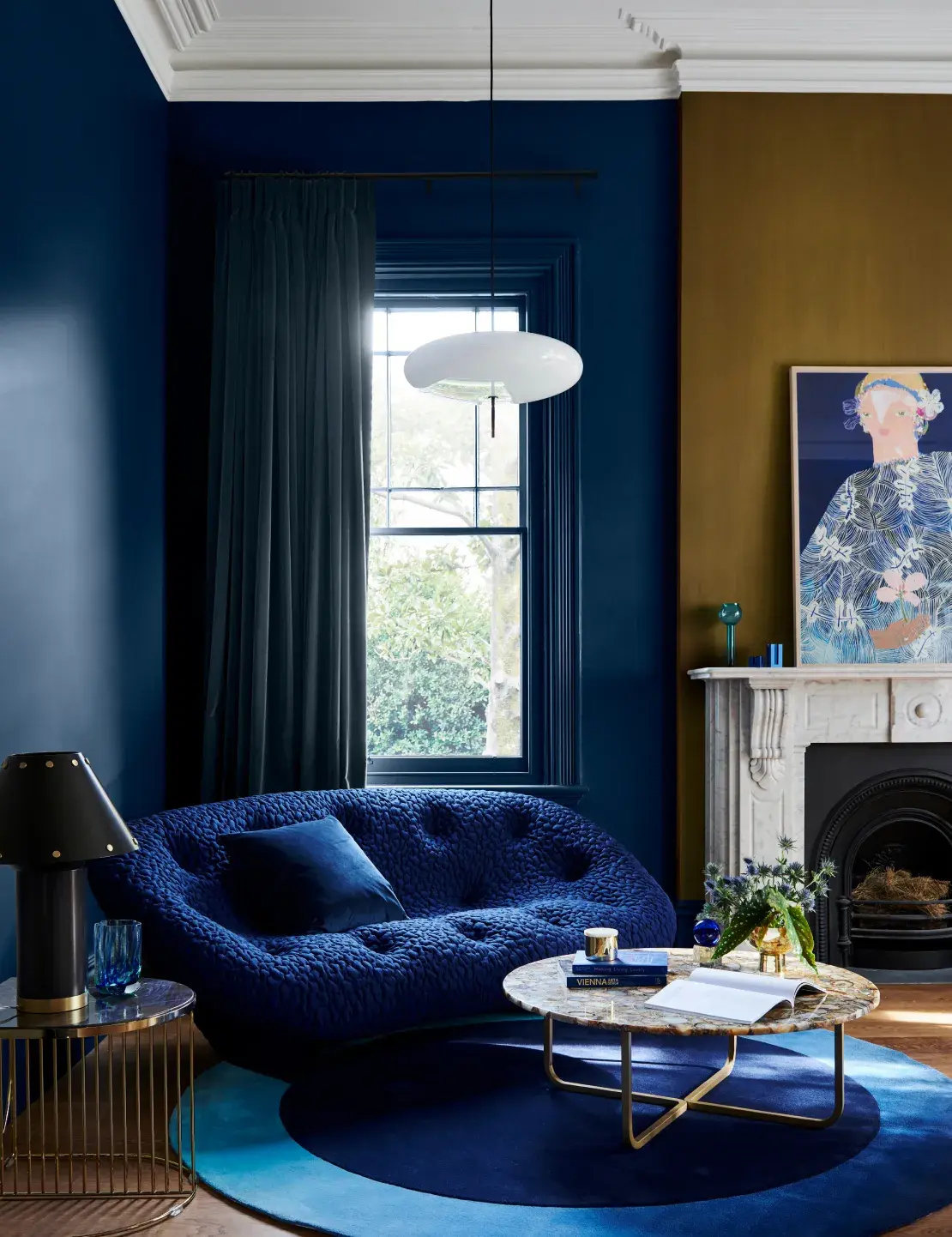 Interior living room with Kenepuru Sound coloured wall, Gold Vintage coloured behind the fireplace, sofa and coffee table