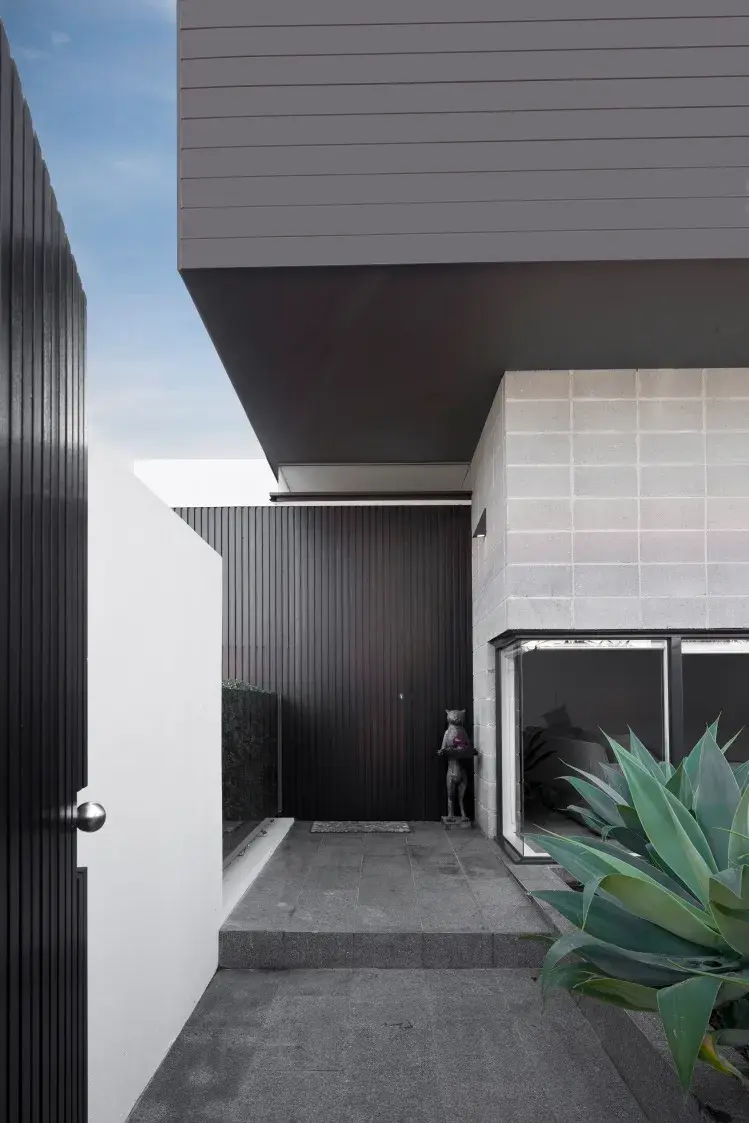 Contemporary exterior with grey fence