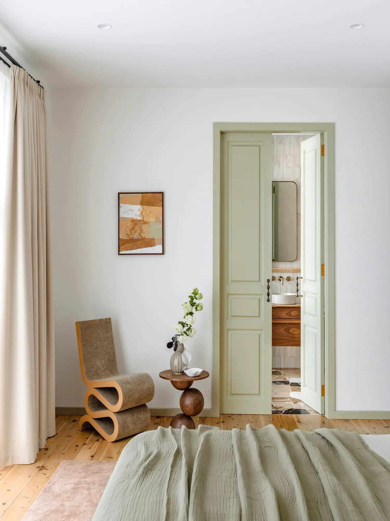 White bedroom with green door after image