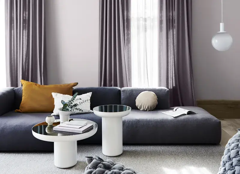 interior purple lounge curtains and couch.