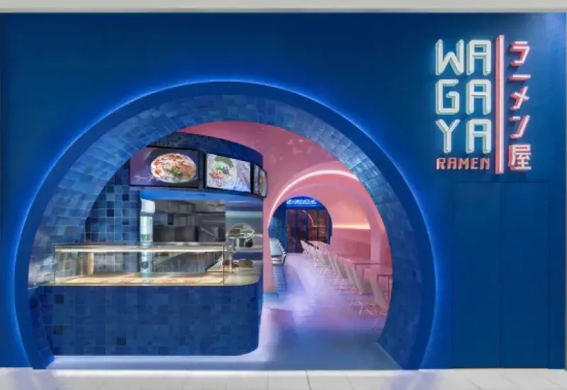 Blue neon circular restaurant entrance with pink interior