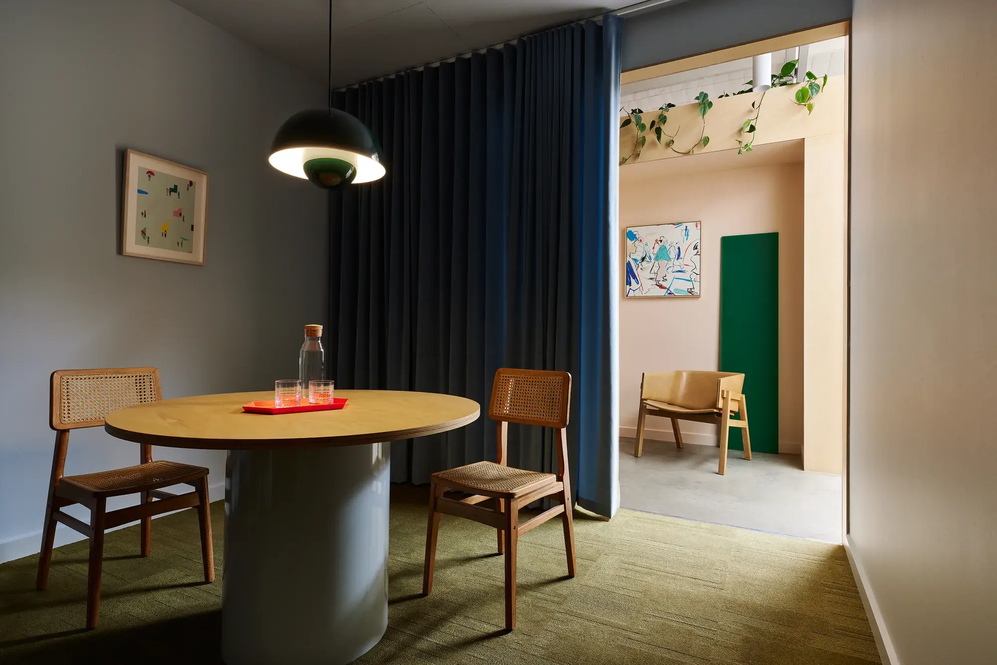 Round dining table with two chairs in dark room 