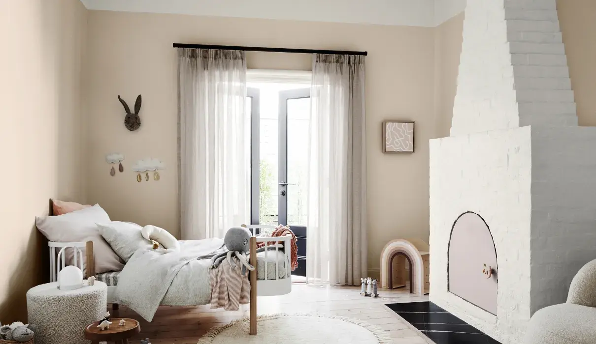 Grounded neutral bedroom with white textured fireplace.