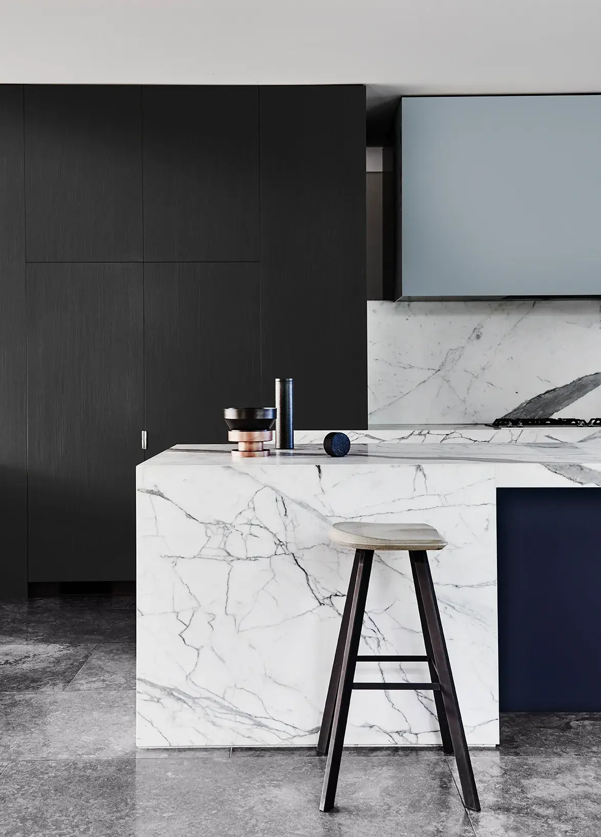 Kitchen with marble bench and black cabinets
