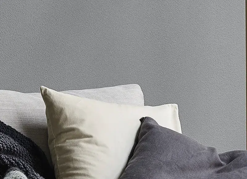 interior close up grey wall and cushions.