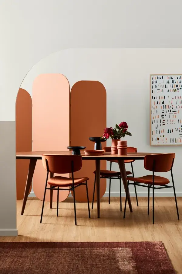 White dining room with orange wall divider