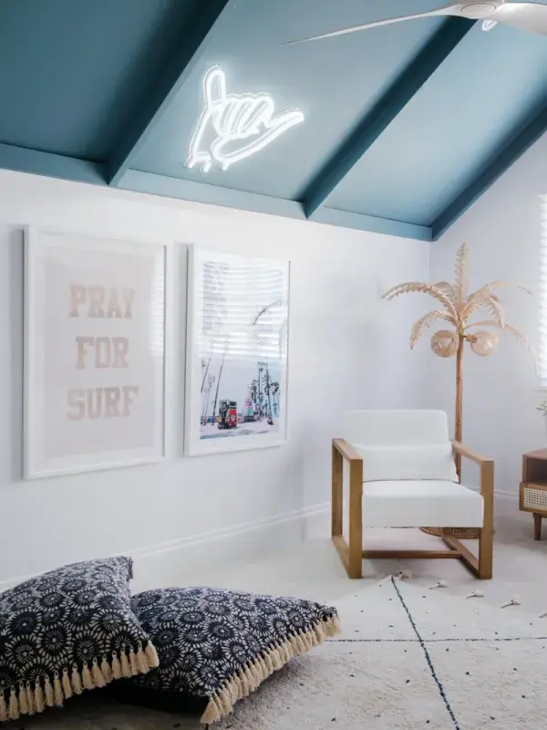 Statement features white wall, ocean coloured pitched ceiling in living area