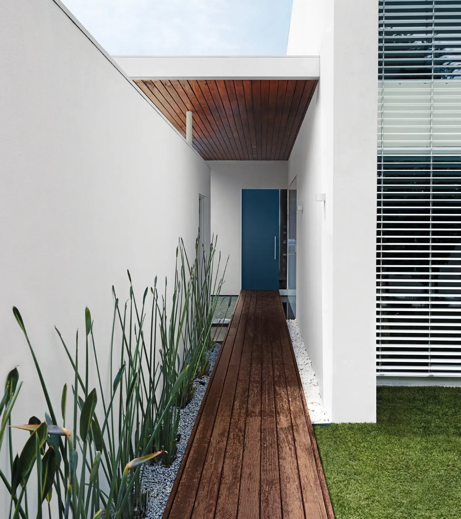 Mordern white house with blue-green door 