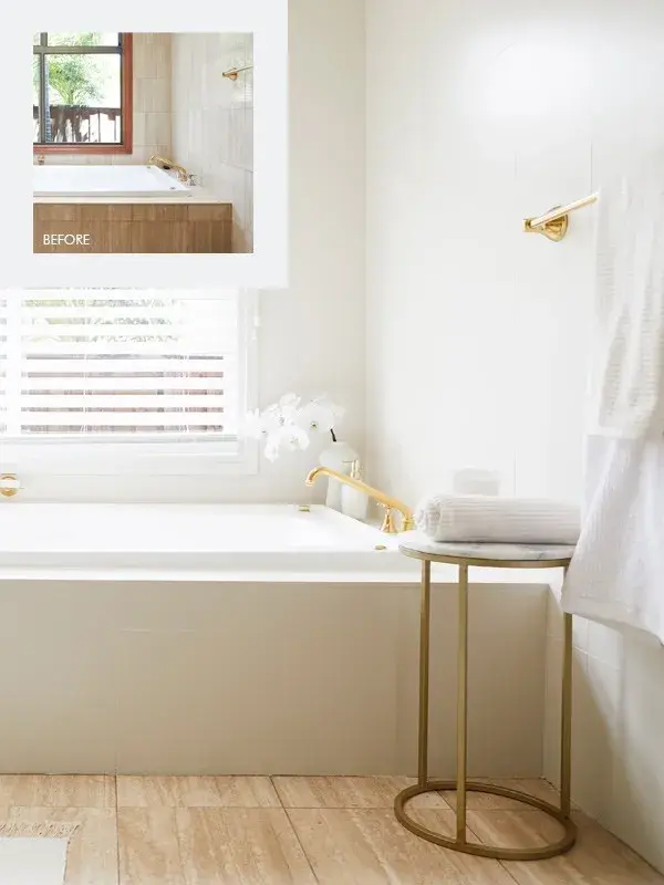 Taking cues from existing tapware, the room features golden towel hooks, sconces and accessories. renovated bathroom with Dulux Renovation Range in Buff It Half 