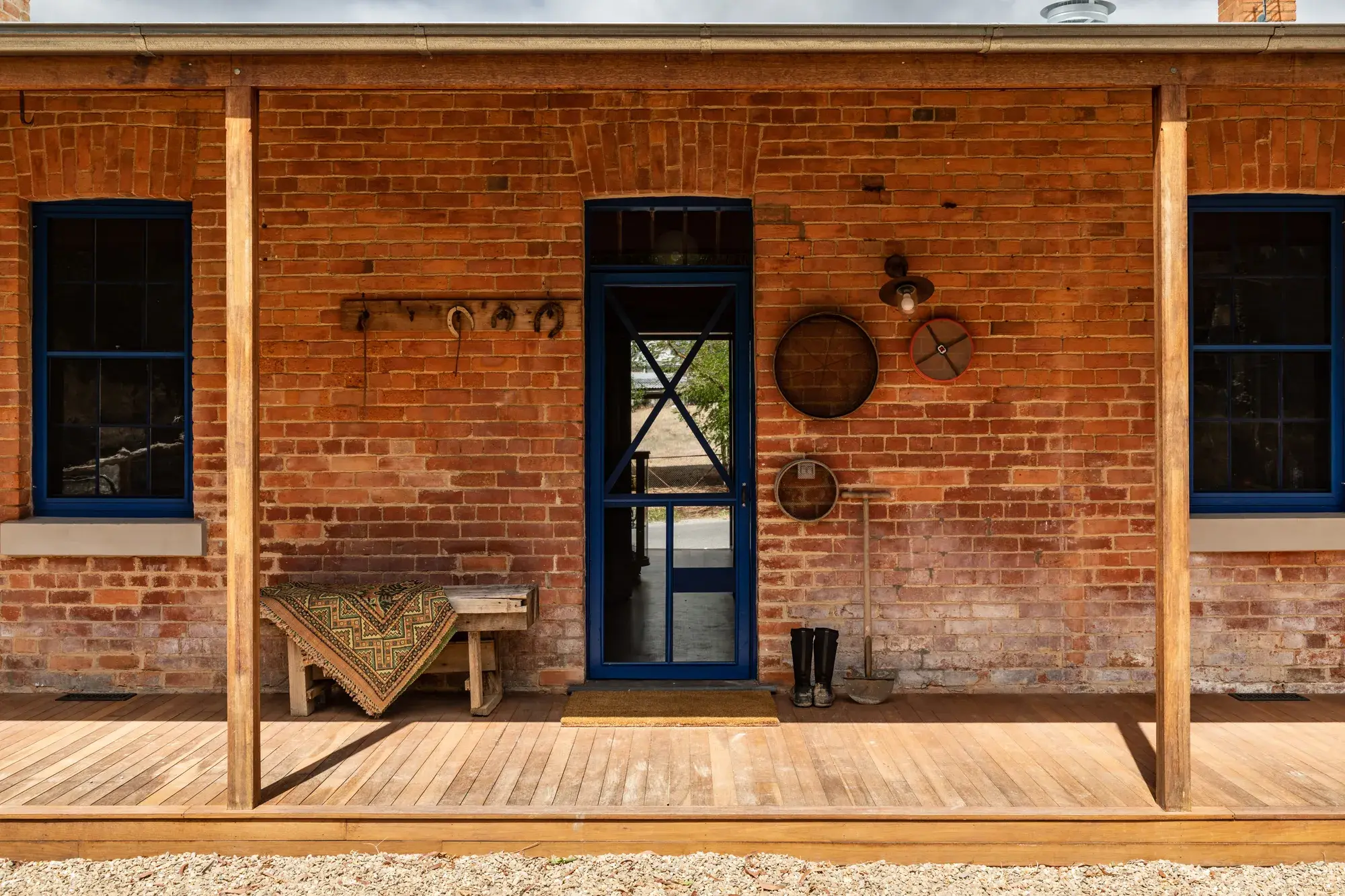 Red brick house with timber verandah posts and deck