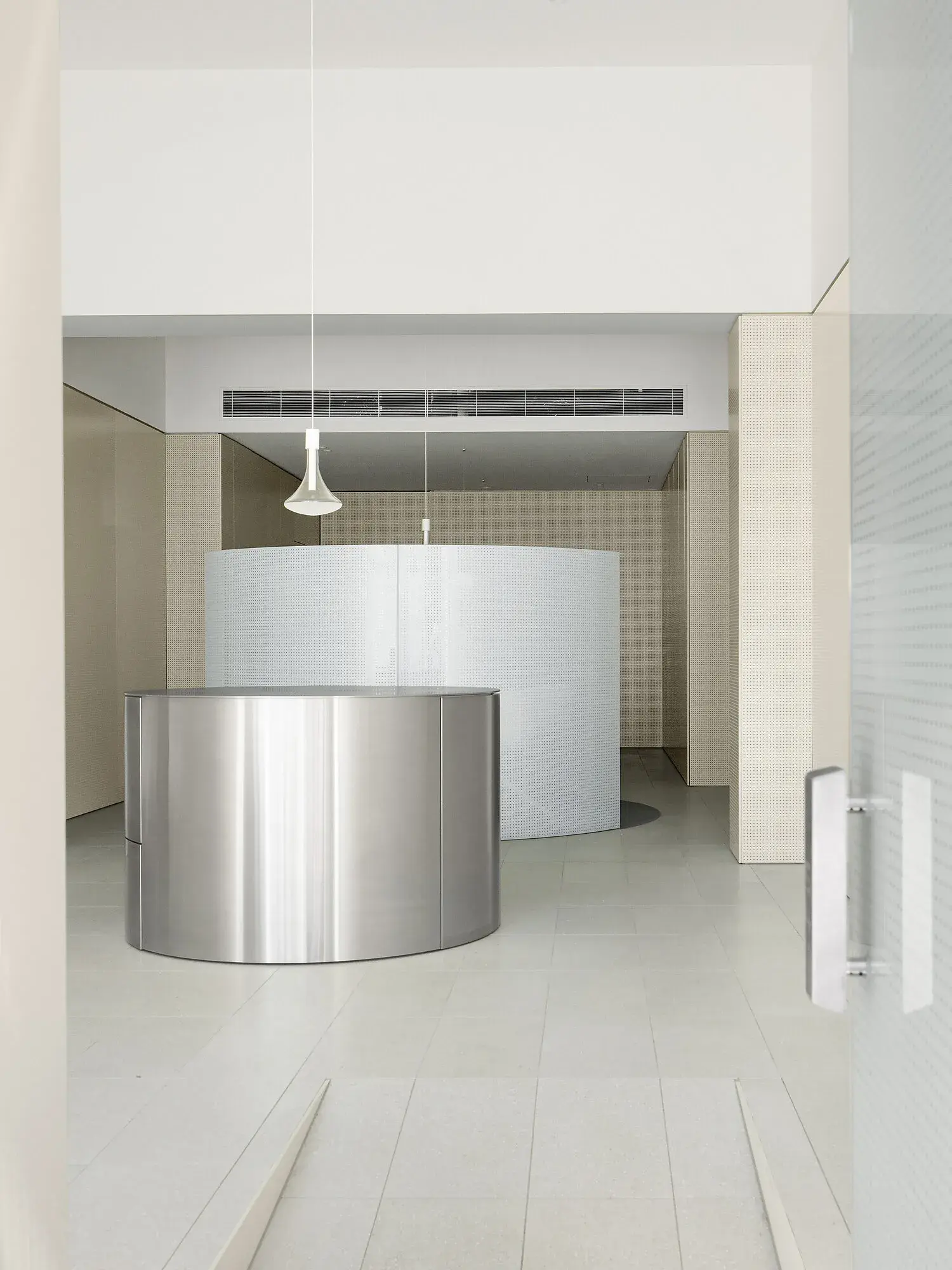 Curved white and silver benches in bar.