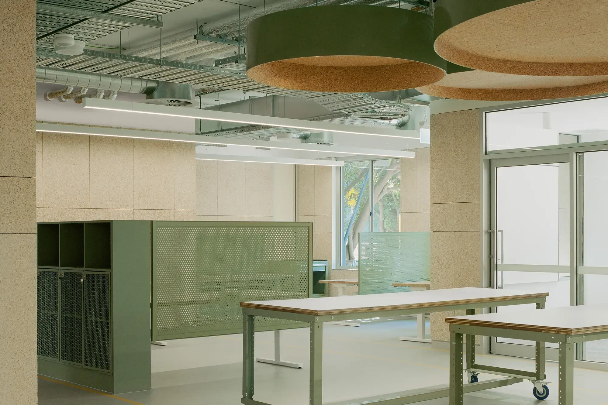 Office with neutral walls and green cabinetry.