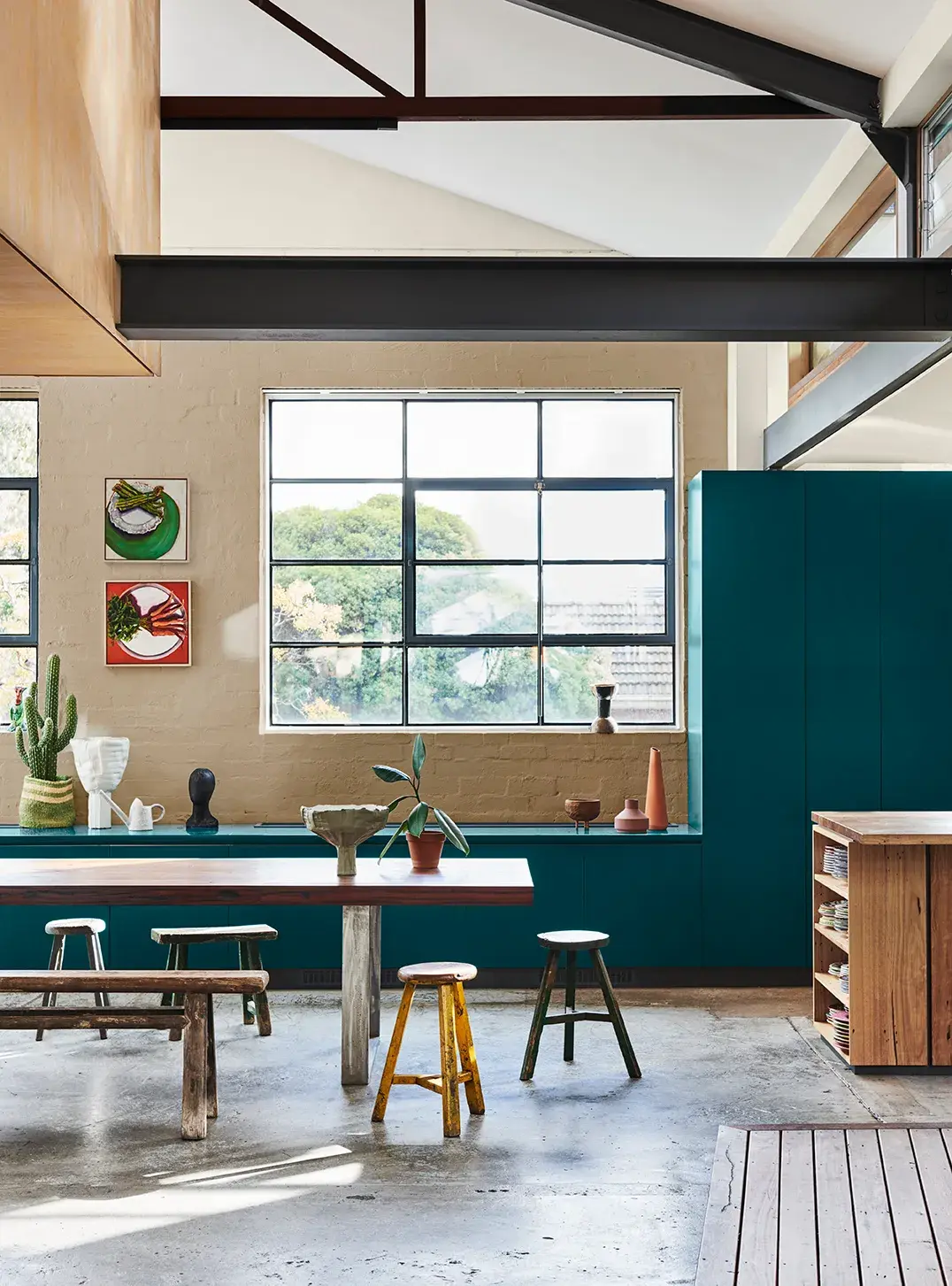 Kitchen with long table and wooden stools