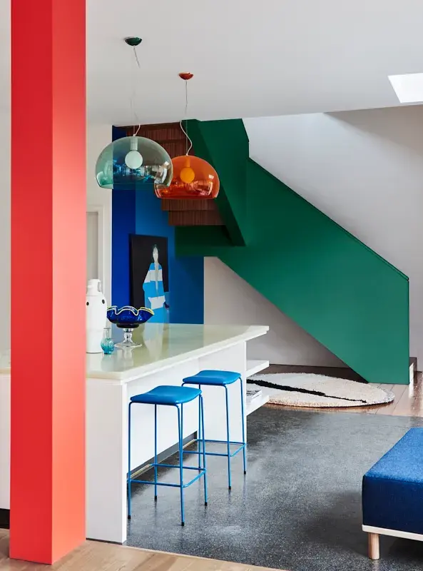 Blue stools under a white kitchen island