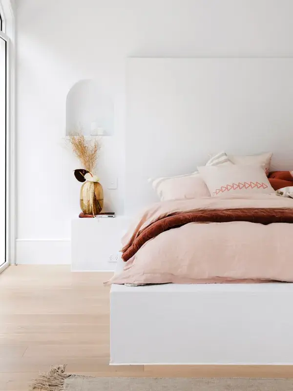 Master bedroom in Dulux White on White with bed in pink linens