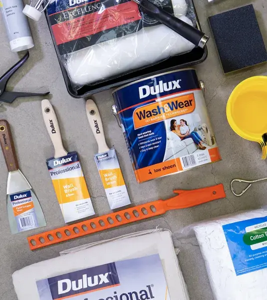 Selection of Dulux paint products arranged on concrete floor