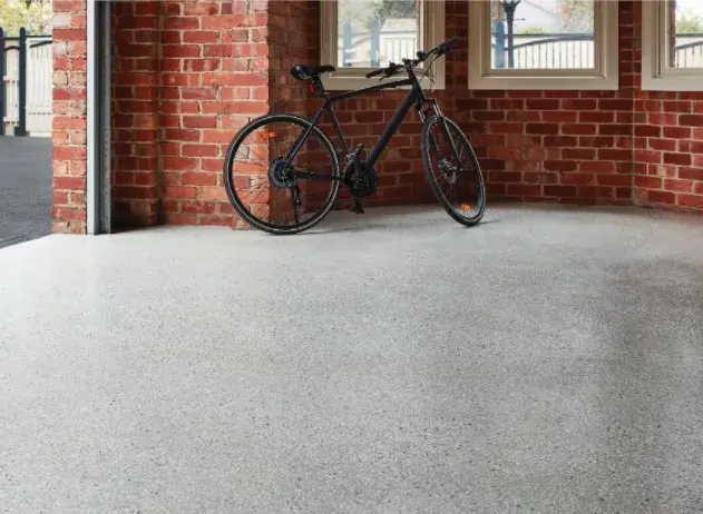 Bicycle parked on a garage floor with Dulux Avista epoxy flooring